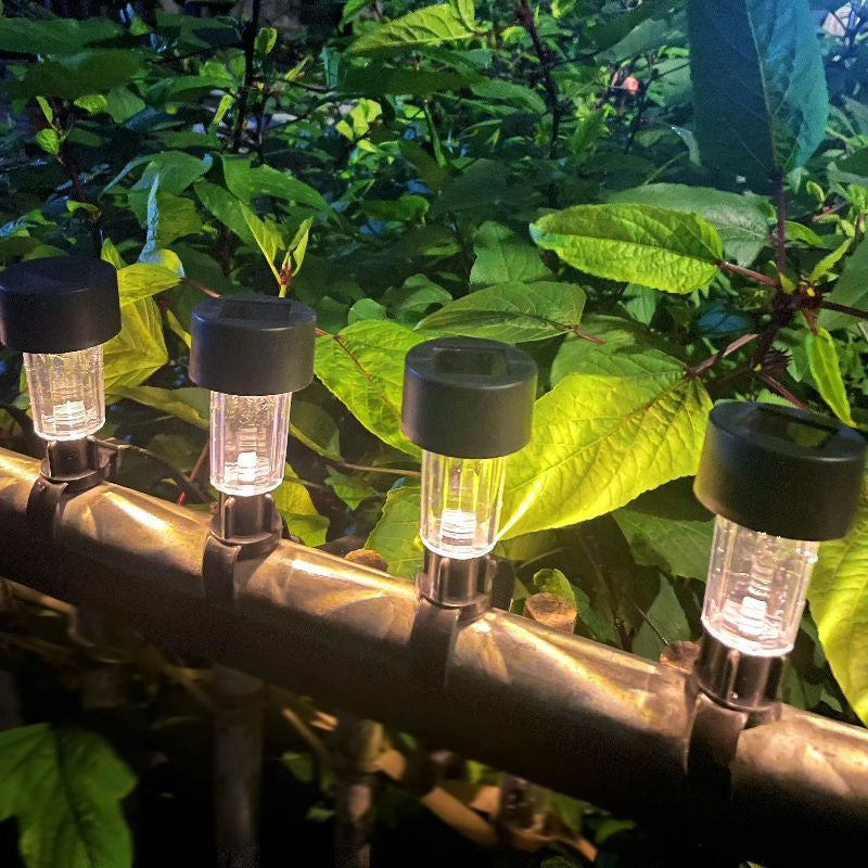 4 pack solar railing lights installed on outdoor fence with warm white glow