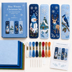 Blue winter bookmark materials arranged with felt thread and needles