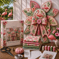 Pink flamingo garden quilt bow displayed with sewing materials