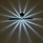Solar railing light casting a starburst light pattern on a wall