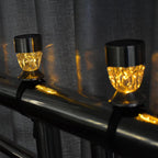 Warm white solar railing lights installed on outdoor deck railing