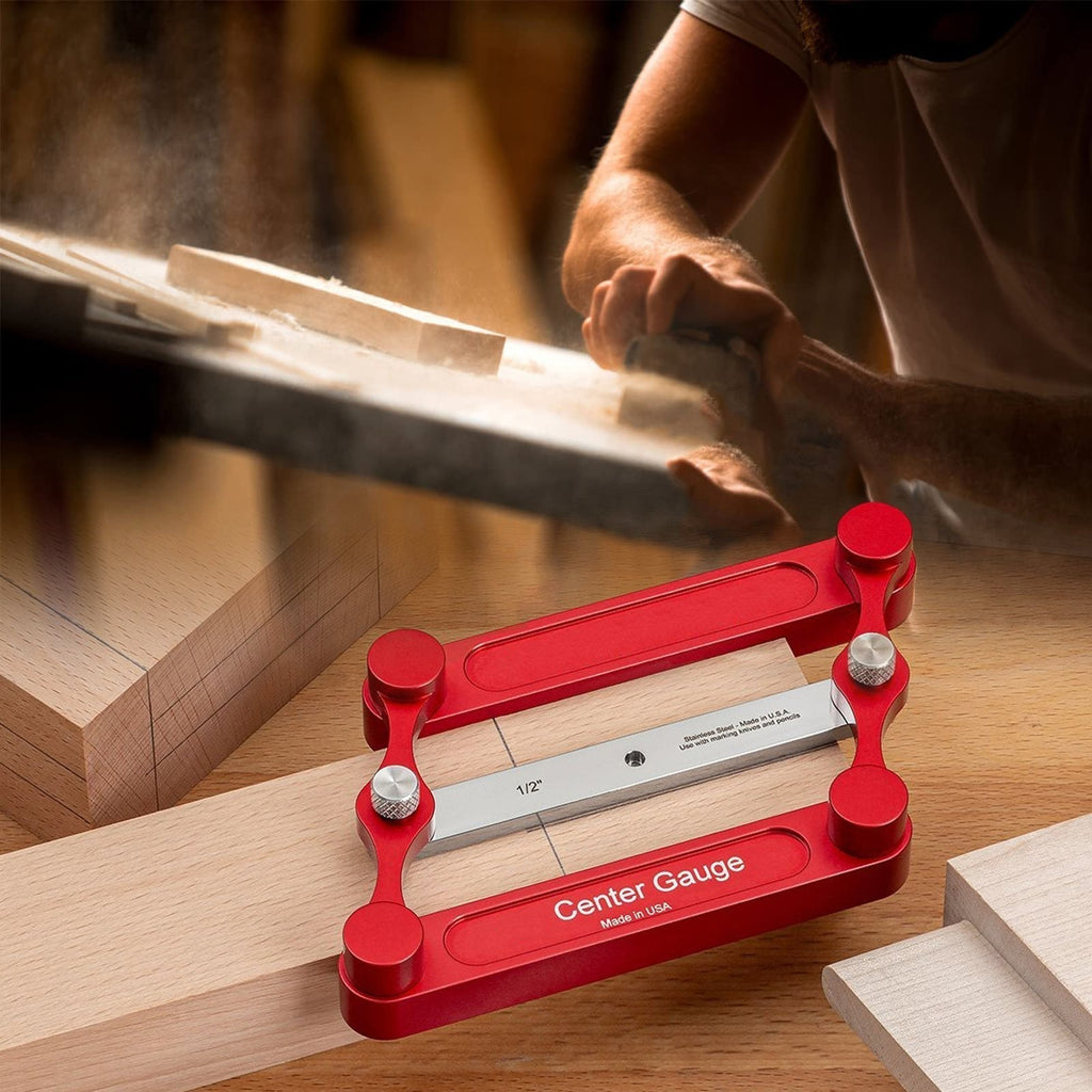 Woodworking center marking gauge placed on a wooden board in a workshop